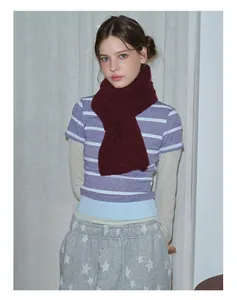 Detailed close-up of dark red wool knit scarf with soft fluffy texture and ribbed pattern