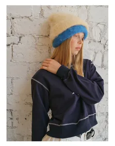 Detail of blue alpaca wool blend beanie showing fluffy knit texture and contrast stitching
