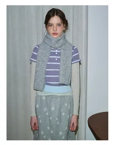 Chunky grey ribbed knit wool scarf styled with casual polo shirt and star print joggers