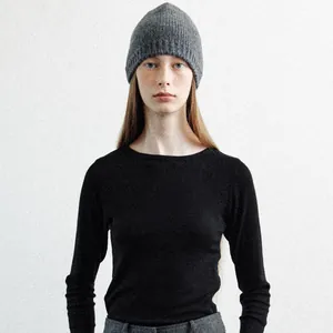 Women's dark grey ribbed wool knit beanie hat shown on model for autumn winter style