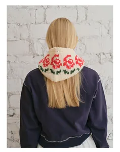 Detail view of knitted wool blend balaclava showing rose floral jacquard pattern and texture