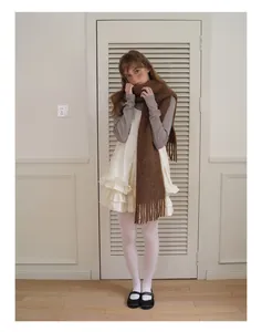 Close-up of deep brown fringed alpaca wool scarf paired with a layered vintage dress