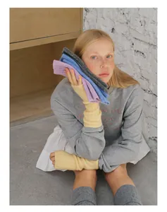 Detailed texture of colorful wool blend knit fingerless gloves in soft pastel colors