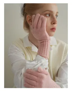 Detail of soft pink pure wool knitted gloves with ribbed long cuffs for women