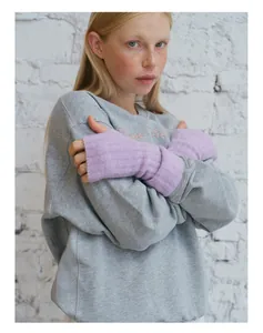 Detail of light purple ribbed wool blend fingerless gloves styled with a grey sweatshirt