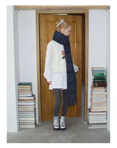 Full view of a vintage plaid wool blend scarf styled with a cozy winter college outfit