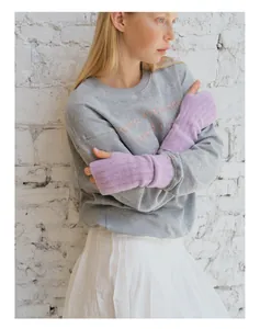 Close-up of lilac wool blend knit fingerless gloves with a grey embroidered sweatshirt