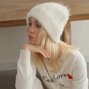 White fuzzy alpaca wool blend beanie hat for women featuring warm knit texture