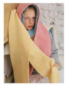 Close-up of soft pastel wool scarves showing warm texture and layered knitting craftsmanship