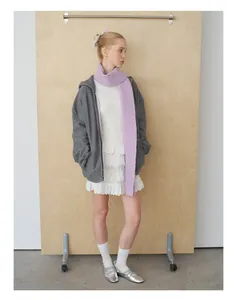 Detail of light purple wool knit scarf styled with grey hoodie and lace dress