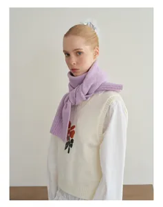 Detailed texture of light purple wool knit scarf paired with a white tulip sweater vest