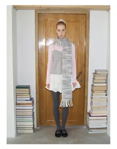 Detail of soft wool blend gradient scarf with tassels styled with a chic layered outfit