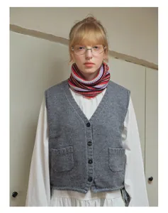 Detail of multi-color striped wool blend knitted neck gaiter and V-neck vest outfit