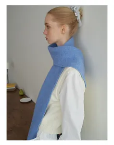 Detail of soft sky blue wool blend knit scarf with fluffy texture and delicate fiber weave