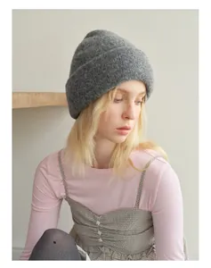 Close-up of a warm grey wool blend beanie showing soft textured knit and folded cuff
