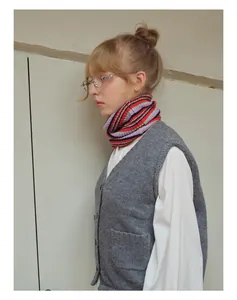 Detail showing high-quality wool blend striped knit neck warmer paired with a grey vest
