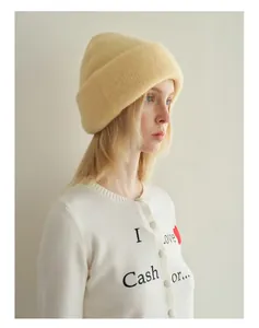 Close-up of yellow wool blend knitted beanie with soft mohair texture on a female model