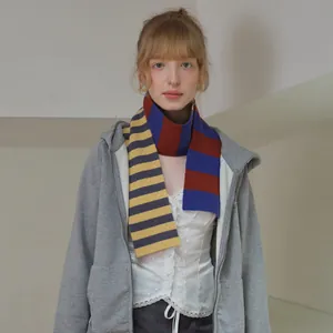 Merino wool scarf with asymmetric yellow, black, red, and blue stripes for women