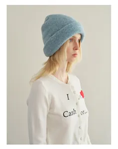 Detail of light blue wool beanie paired with a white heart embroidery cardigan