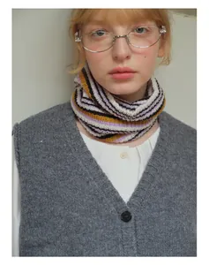 Detailed knit texture of wool blend striped neck gaiter in purple, black, and yellow
