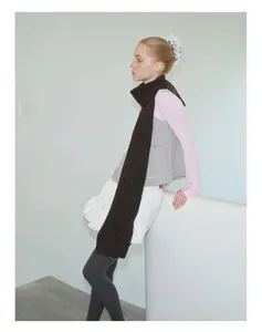 Detail of soft dark brown wool knit scarf showing thick fiber texture and long design