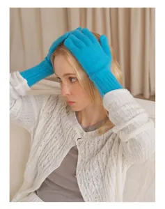 Detail of bright sky blue raccoon wool blend gloves with ribbed cuffs and touchscreen feature
