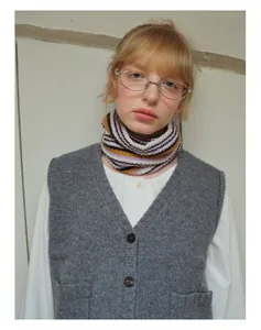 Close-up of striped wool blend knit neck warmer in purple and yellow on a model