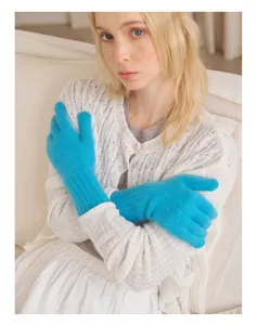 Detail of teal long knit gloves with ribbed cuffs and fluffy raccoon wool texture