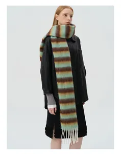 Detailed close-up of fluffy striped wool scarf featuring elegant long white tassels