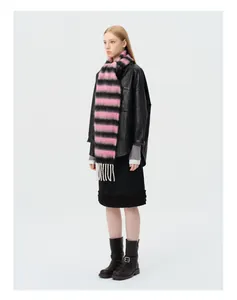 Close-up of pink and black striped alpaca wool scarf with white fringe and leather jacket