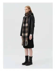 Full body view of a thick wool blend plaid scarf with tassels on a fashion model