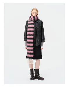 Detail of pink and black striped alpaca wool scarf with white tassel fringe and soft texture