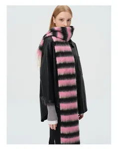 Detail view of pink and black striped wool scarf with fringe on a model with leather jacket