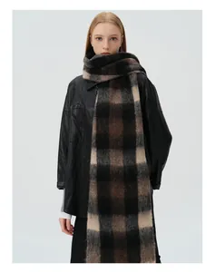 Close-up of thick wool blend checkered scarf with soft fringe and fuzzy texture