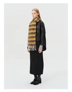 Detailed view of striped alpaca wool blend scarf with fringe tassels on model