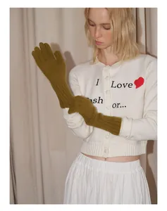 Close-up of olive green long knit gloves with textured ribbed cuffs and wool blend fabric