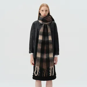 Thick wool blend plaid scarf in black and brown tones with long fringe details