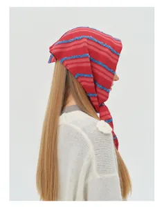Detail of red and pink striped wool blend knit scarf with textured blue accents