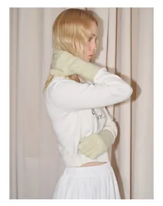 Pale green long knit gloves in raccoon wool blend shown on a model for winter style