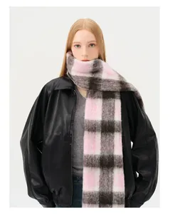 Detail of soft pink and grey checkered wool scarf with long fiber fuzzy texture