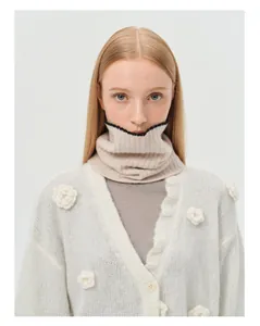Detailed knit texture of 100% wool neck warmer with soft pearl edge and floral accents