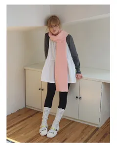 Detailed view of long pink fuzzy wool blend scarf paired with autumn chic winter outfit