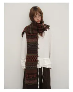 Detailed knit texture of wool blend Fair Isle scarf with retro patterns and tassels
