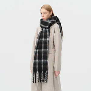 Thick wool blend checkered scarf with fringes paired with minimalist beige long coat