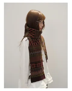 Close-up of Fair Isle knit wool scarf featuring geometric patterns and fringe detail