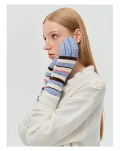 Close-up of colorful striped knit gloves in rainbow wool blend with soft texture