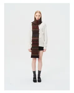 Detailed view of Fair Isle wool blend scarf with vintage patterns and tassel fringe