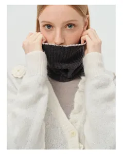 Close-up of white wool knit collar featuring delicate 3D floral embroidery details