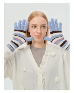 Macro shot of striped knit gloves with finger openings and 3D flower cardigan detail