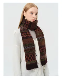 Detail of wool blend Fair Isle jacquard scarf with retro geometric patterns and raw edges